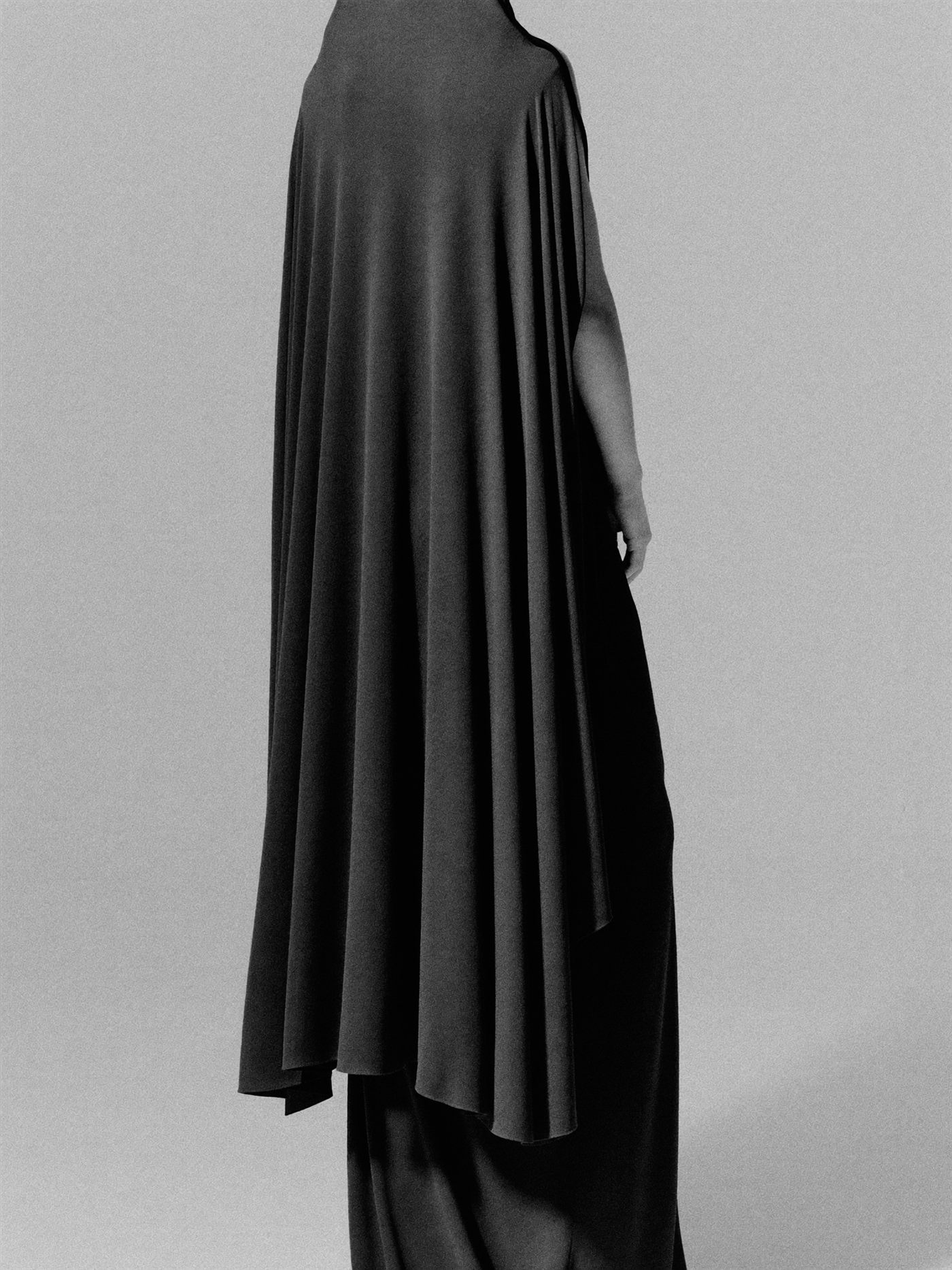 Contemporary abaya-inspired silhouette in deep black, monochrome.